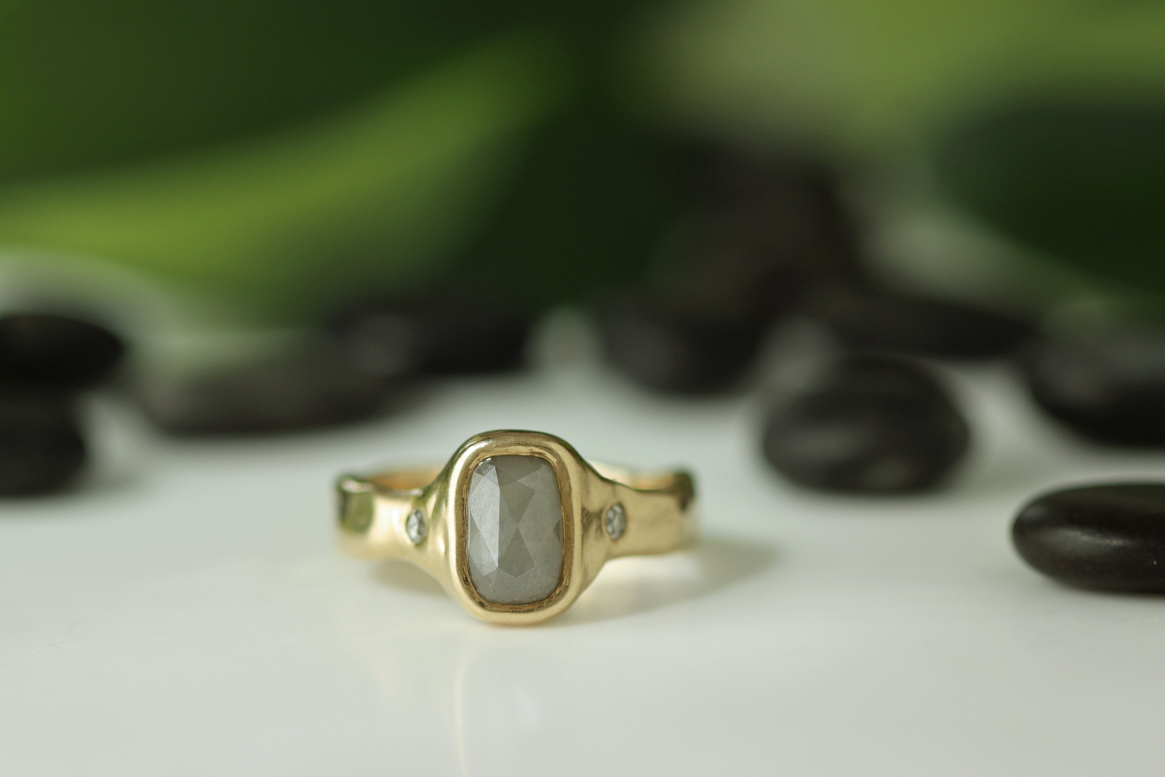 yellow gold ring with large rose cut grey diamond with two small round diamond side stones