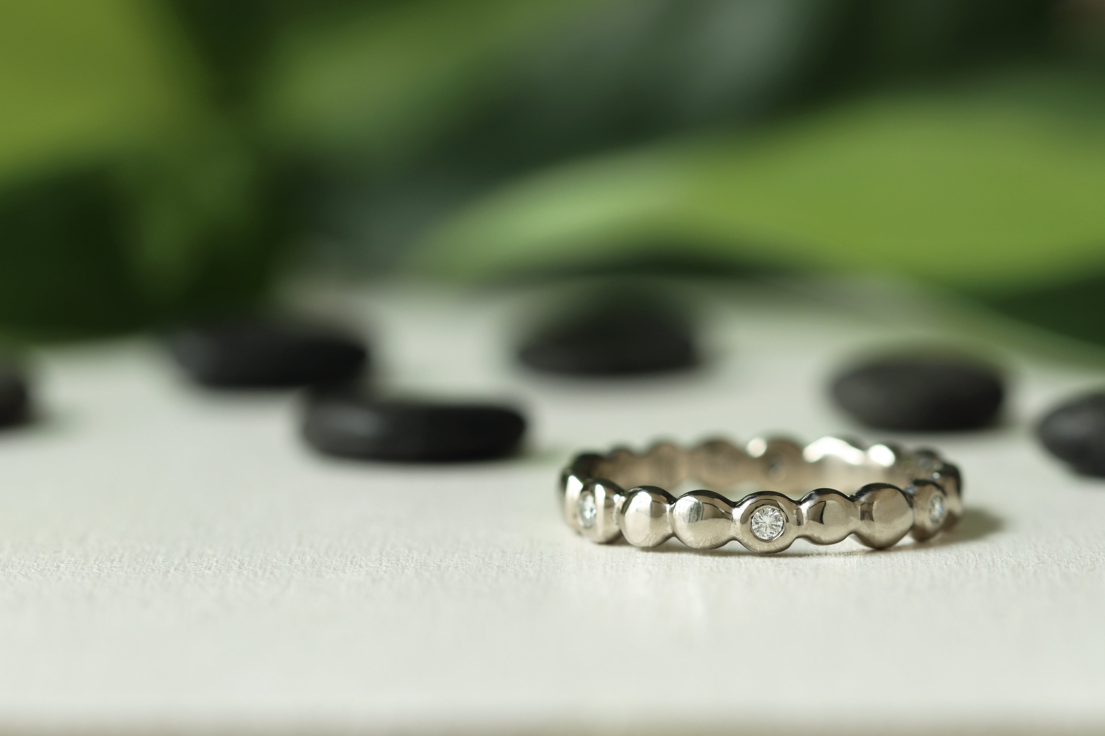 palladium white gold pebble band with scattered flush set diamond